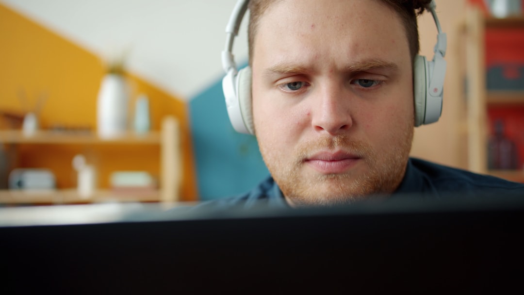 Person wearing headphones while focused on computer work