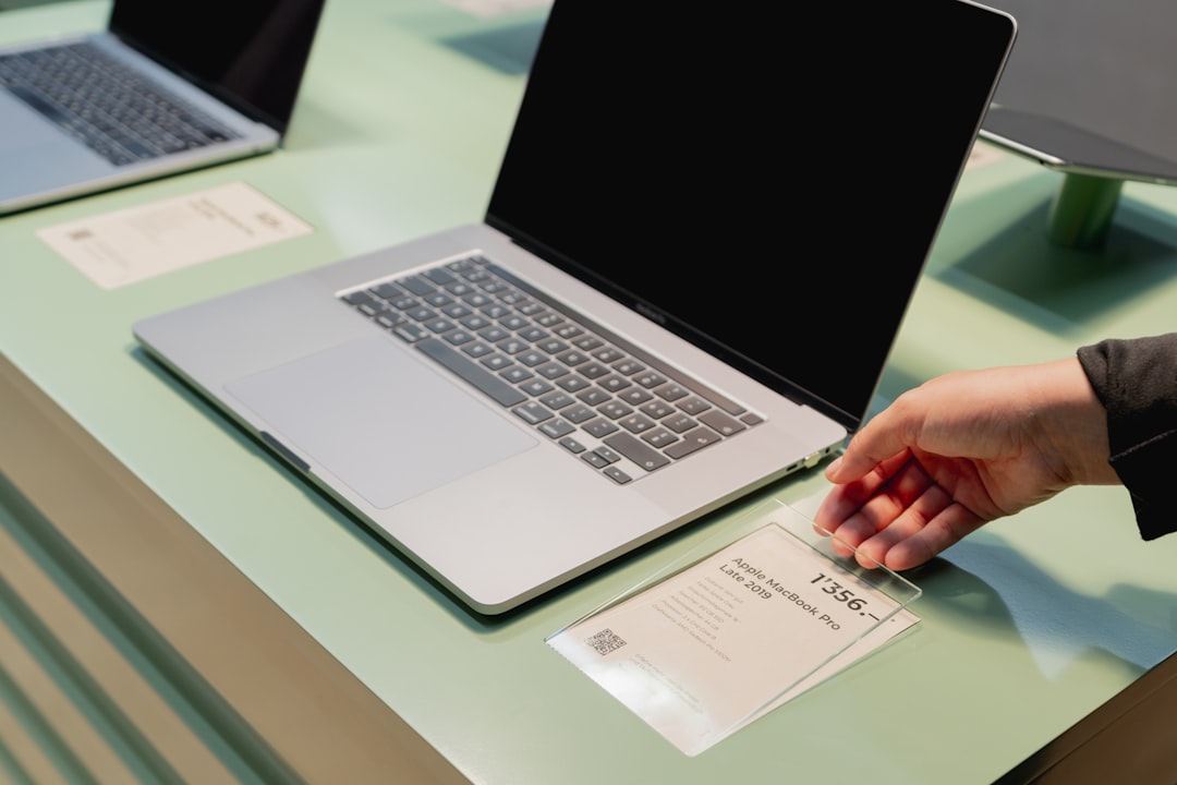 Person choosing laptop store comparison