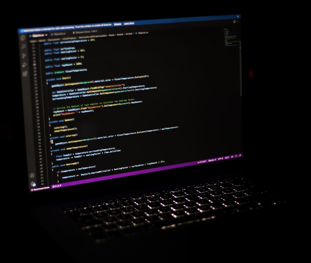 Laptop and keyboard on desk for coding