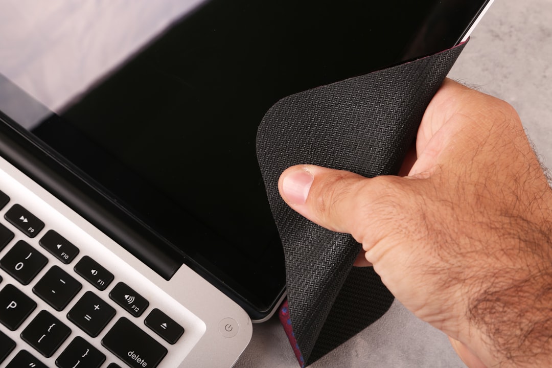Cleaning laptop screen with microfiber cloth