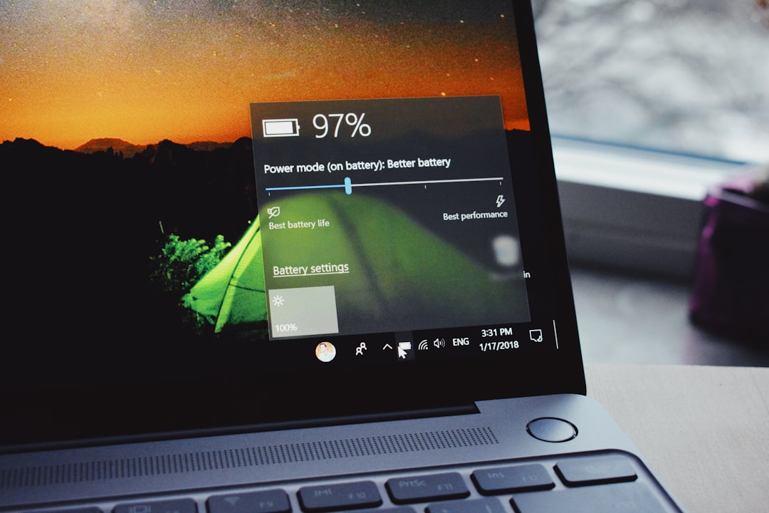 Laptop battery charging on desk
