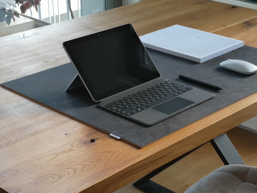 Leather desk mat covering workspace surface