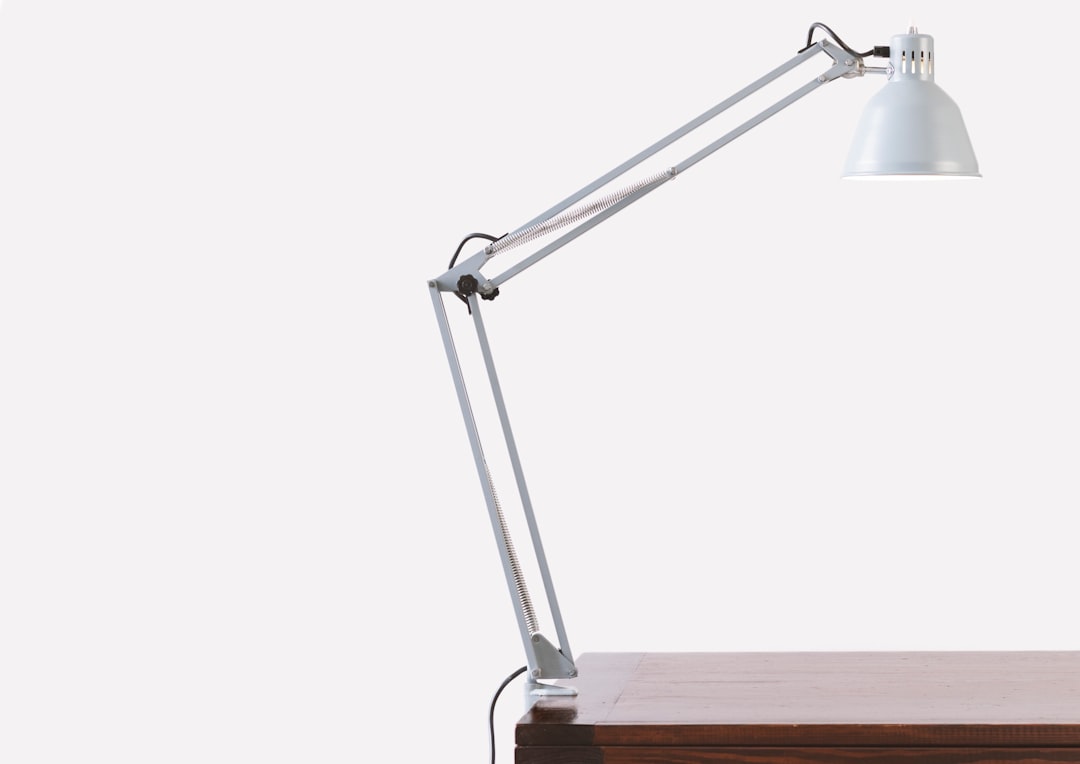 Swing arm LED desk lamp on workspace