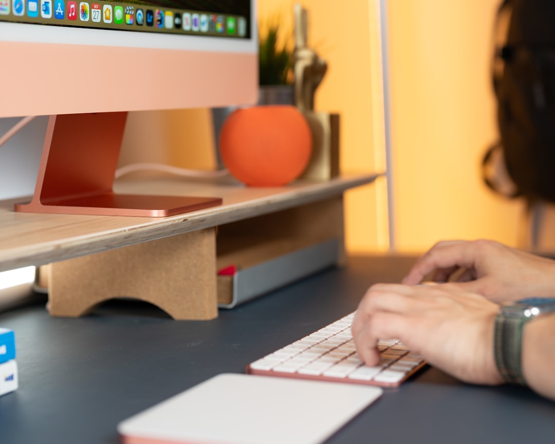 Standing desk with a clean monitor setup in a bright room