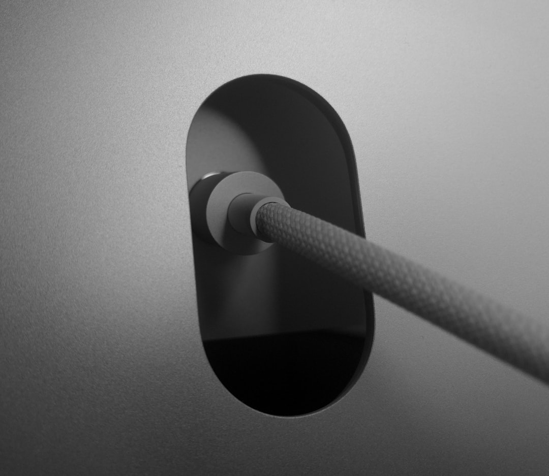 Adhesive cable clips on desk surface