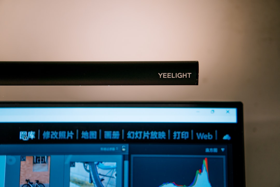 Monitor light bar illuminating a desk workspace