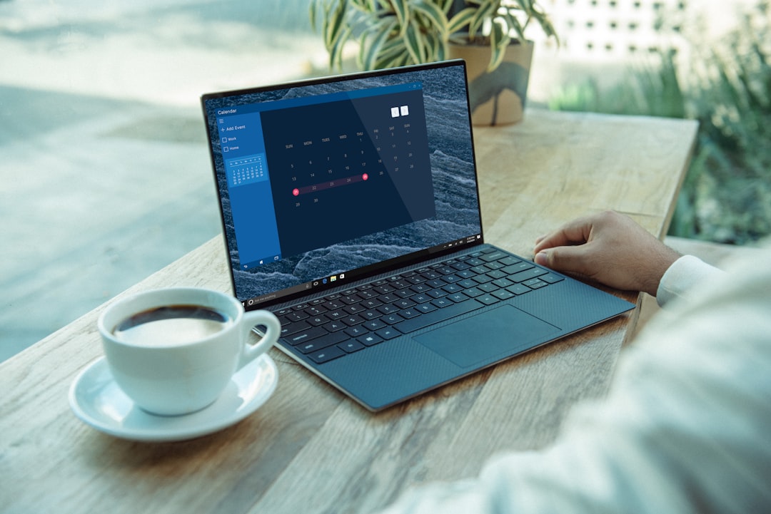 Productivity workspace with laptop and software on screen