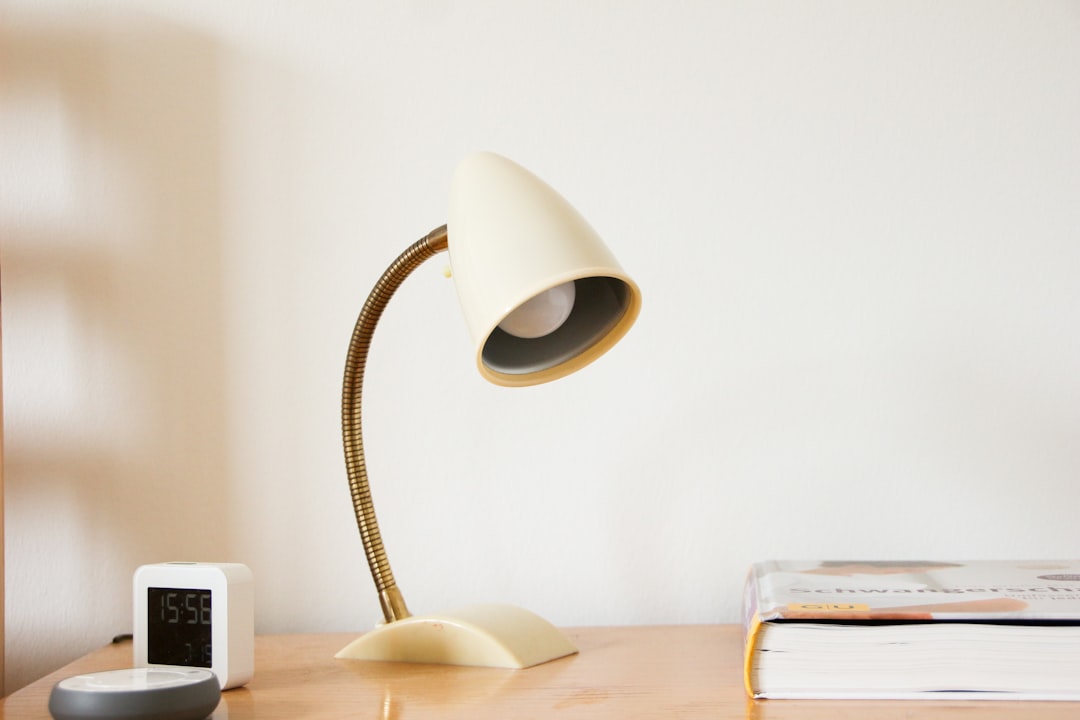 Modern desk setup with notebook and lamp