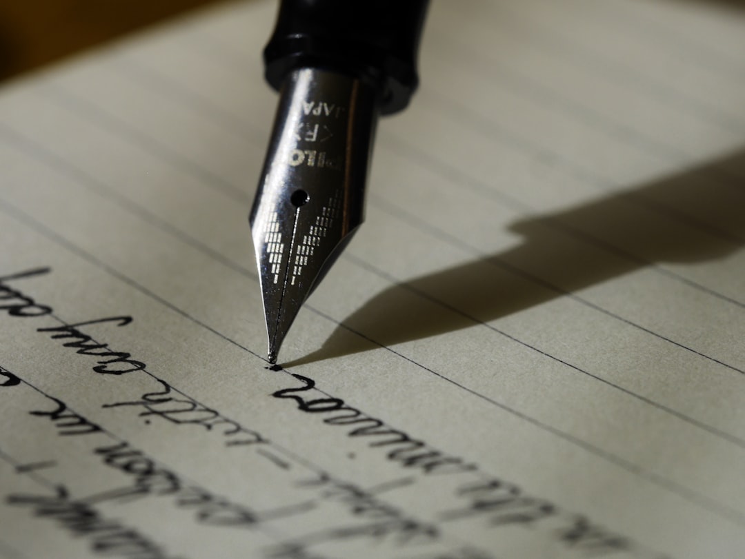 Close up of pen writing on paper surface