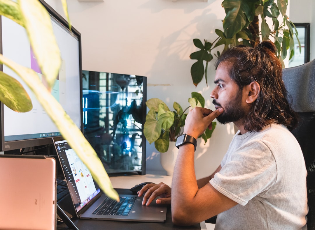 Person working at a desk with a laptop in a home office