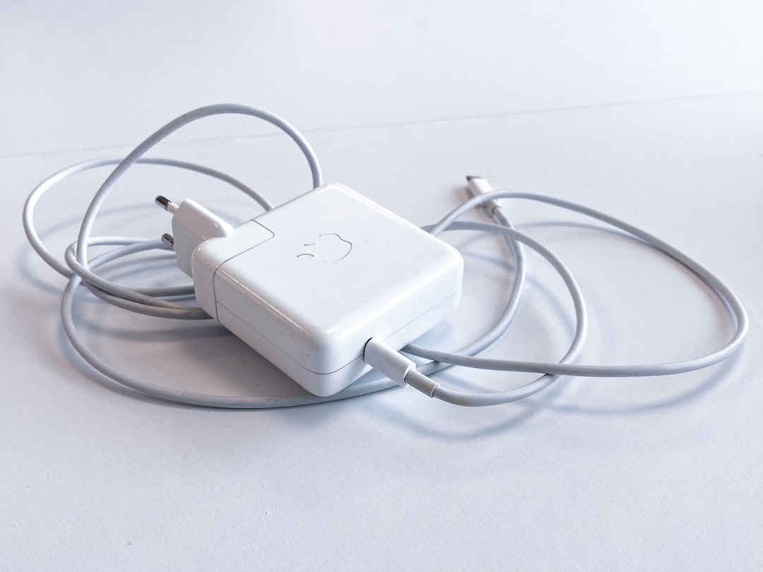 USB-C cable connected to laptop charging port close-up