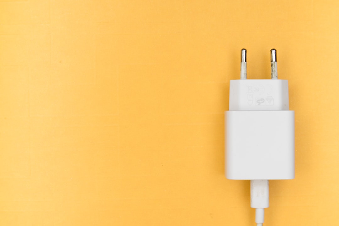 Compact GaN wall charger plugged into a power outlet