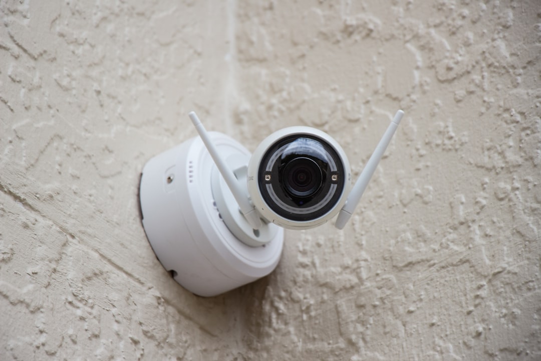 white security camera mounted on exterior wall