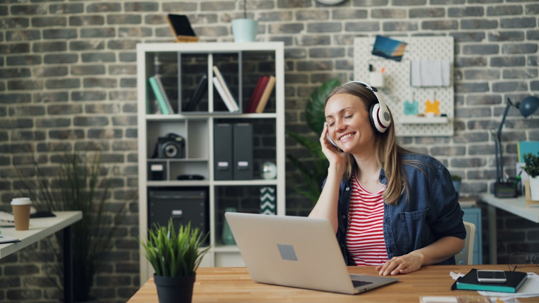 Person wearing over-ear headphones while working