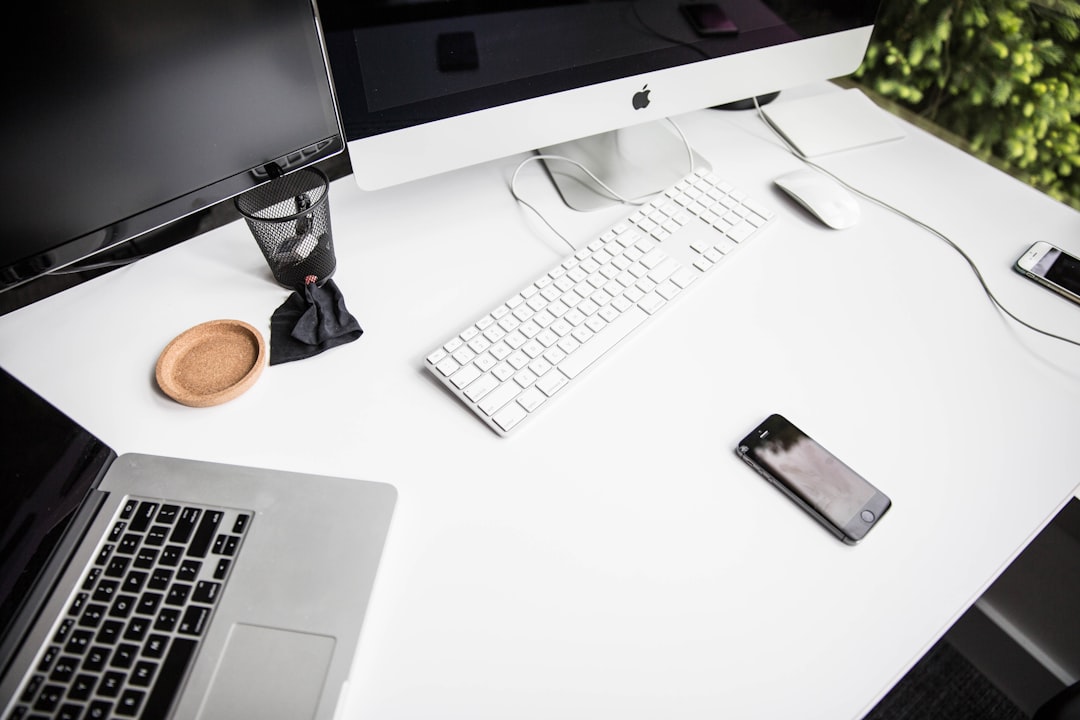 Desk workspace with laptop and phone showing multiple devices needing power
