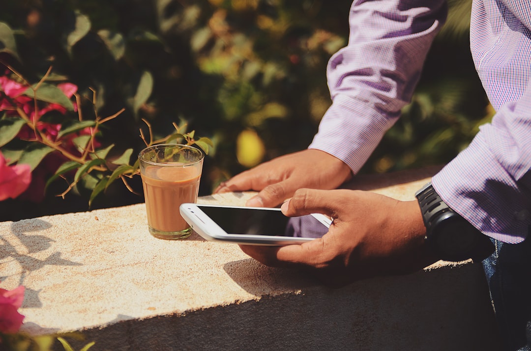 Person checking health data on phone during morning routine