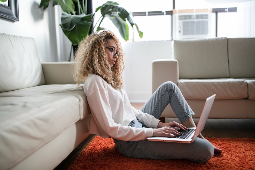 Woman working comfortably on couch with laptop