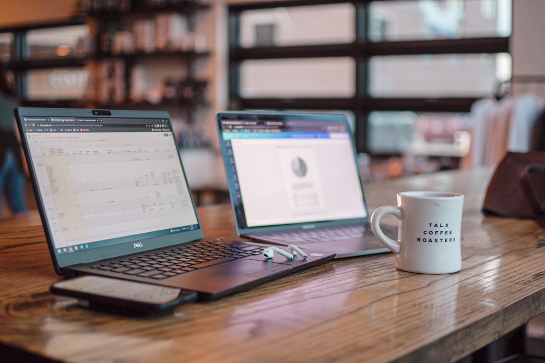 Portable monitor next to laptop in coffee shop workspace