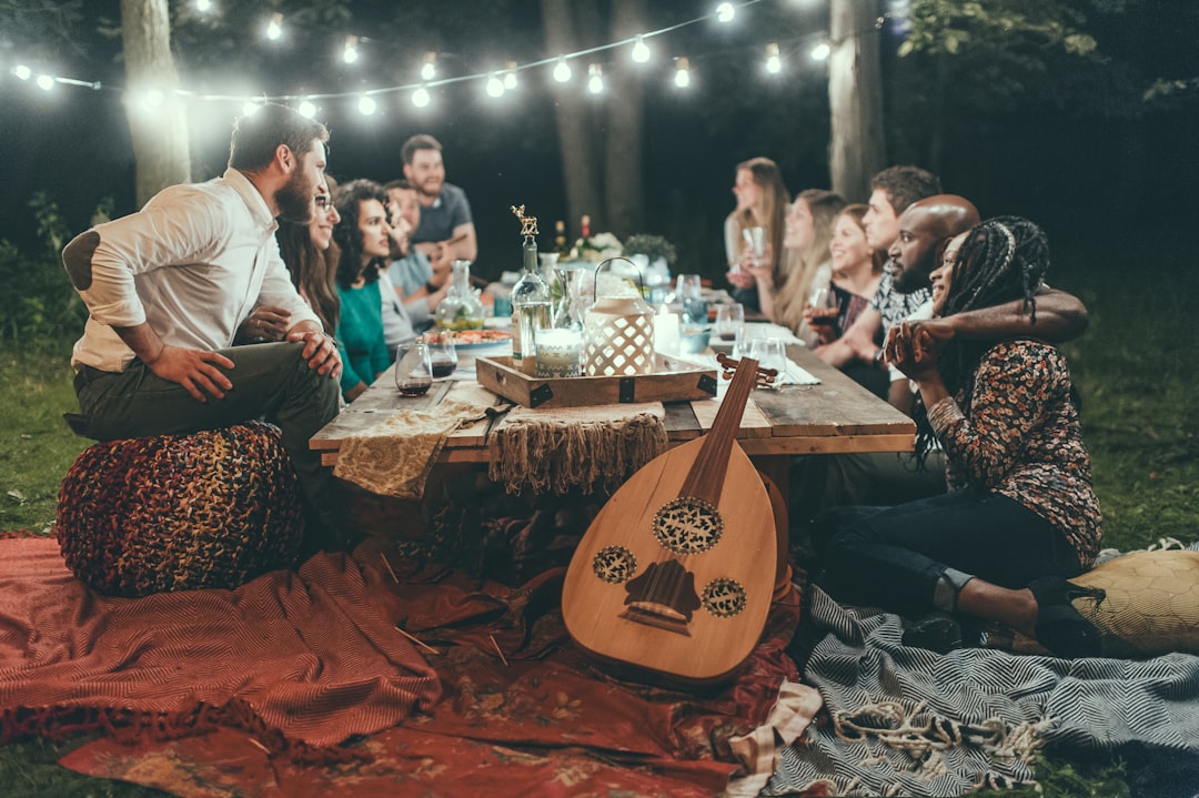 Friends gathered in a backyard with string lights and outdoor seating