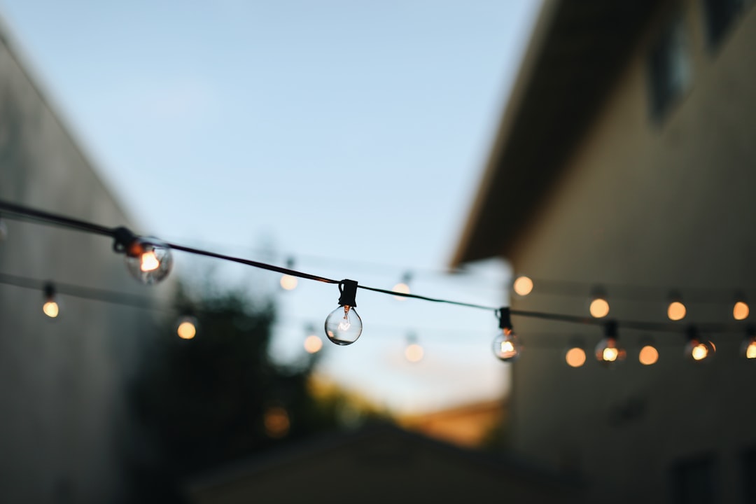 Warm outdoor string lights hung across a patio in the evening