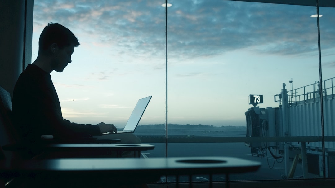Traveler working on laptop at airport gate