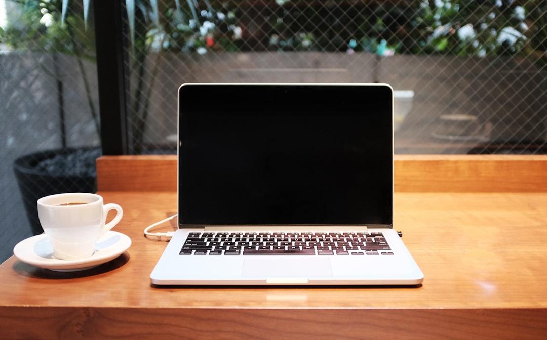 Digital nomad working remotely at cafe with laptop