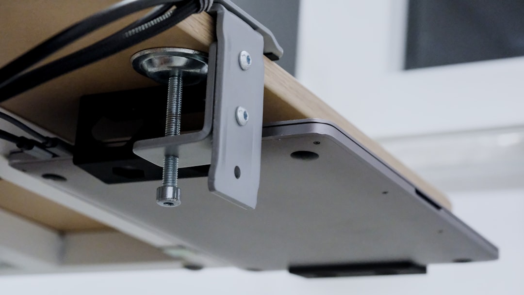 Compact walking pad treadmill stored under a desk at home