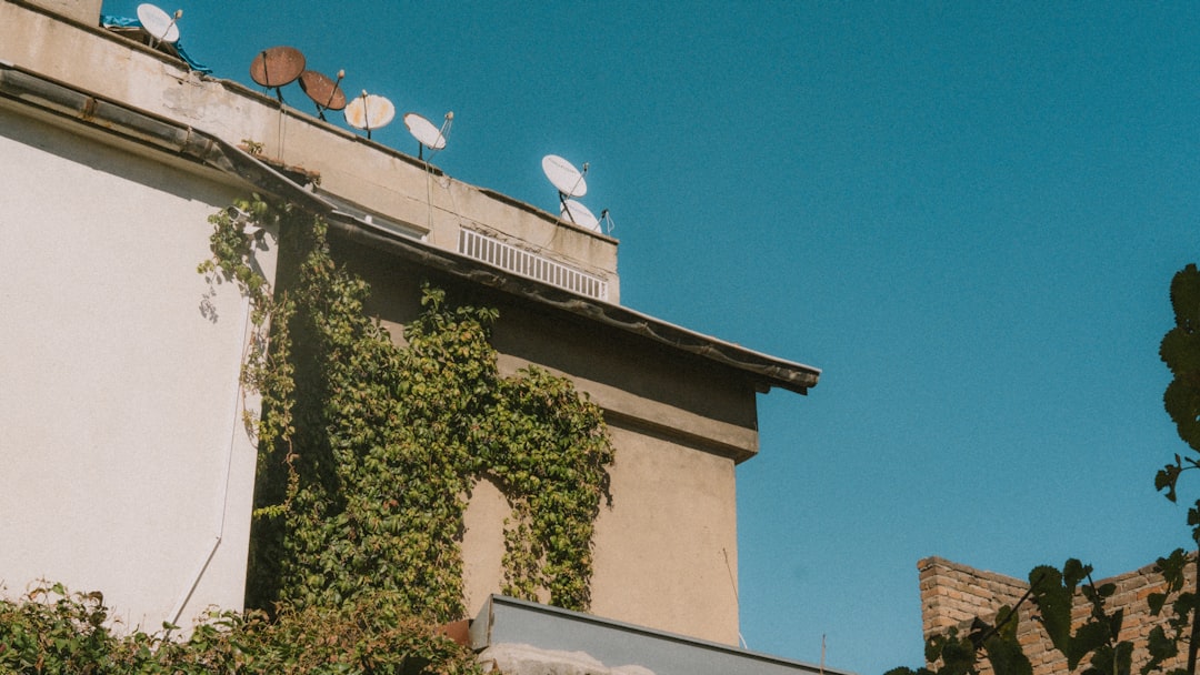 Outdoor WiFi extender mounted on the side of a house