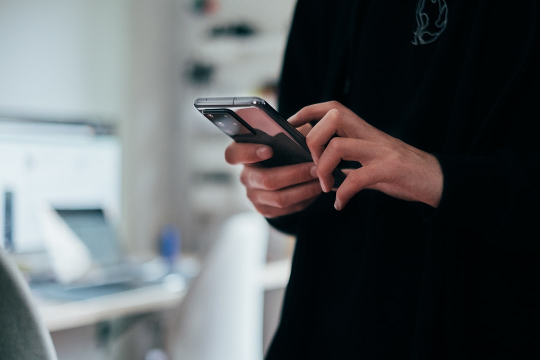 Person using a smartphone app to control smart home devices