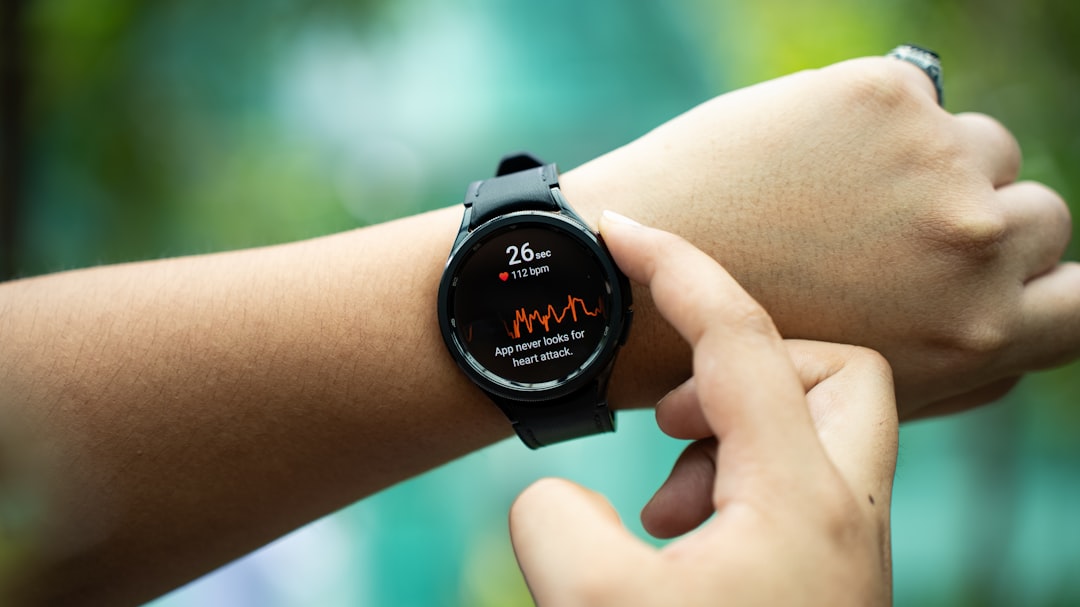 Person running outdoors using a GPS smartwatch for fitness tracking