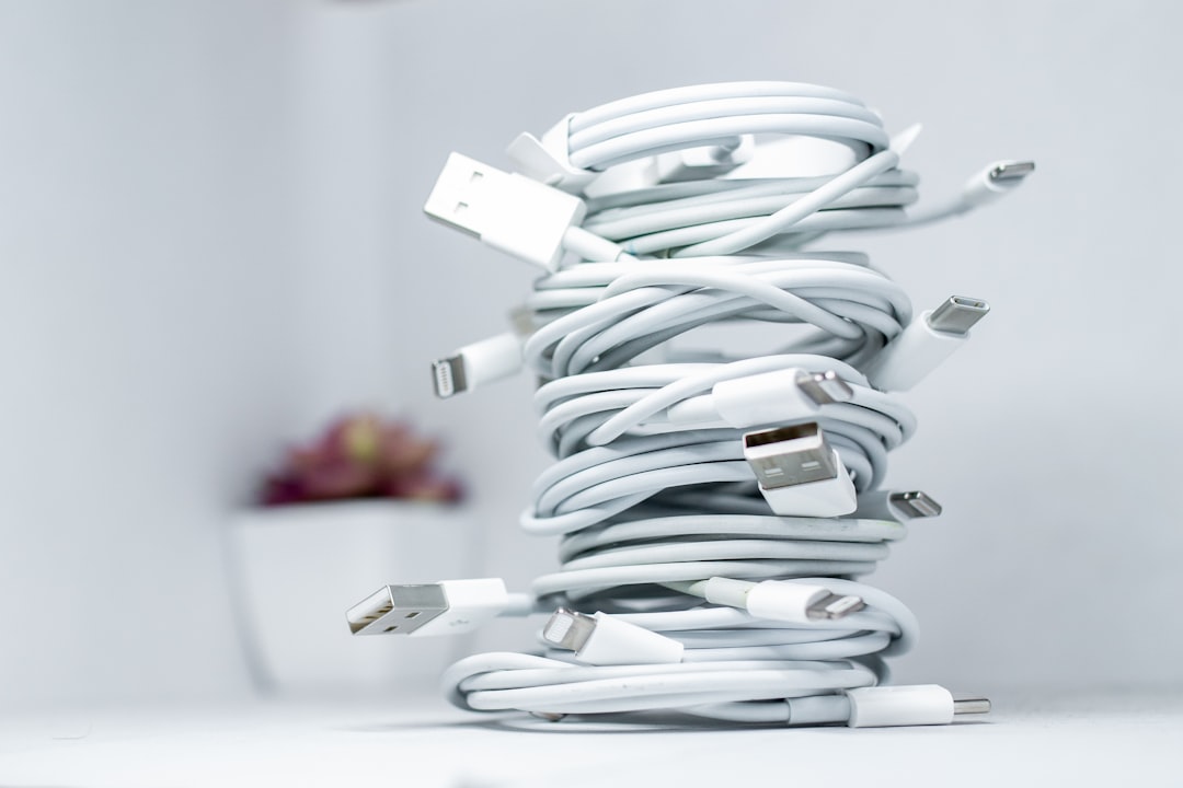 Tangled charging cables cluttered on a desk
