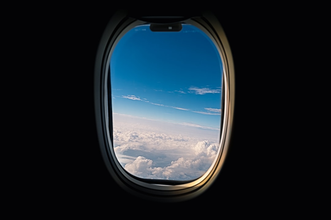 Working on laptop at airplane window seat tray table