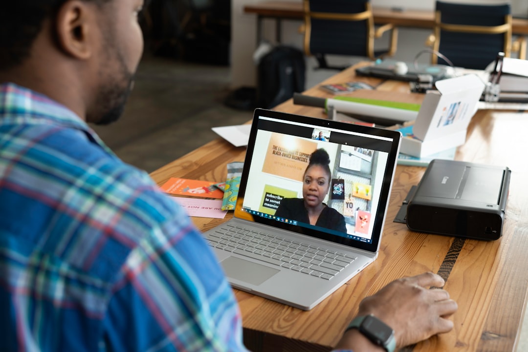 Person wearing an over-ear headset during a video call