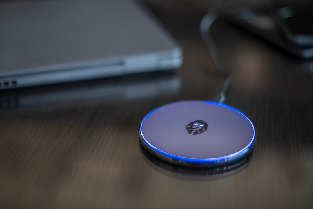 Smartphone on wireless charging pad on desk