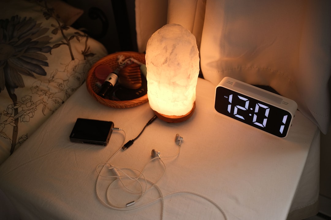 Warm bedside lamp glowing on a nightstand in the evening