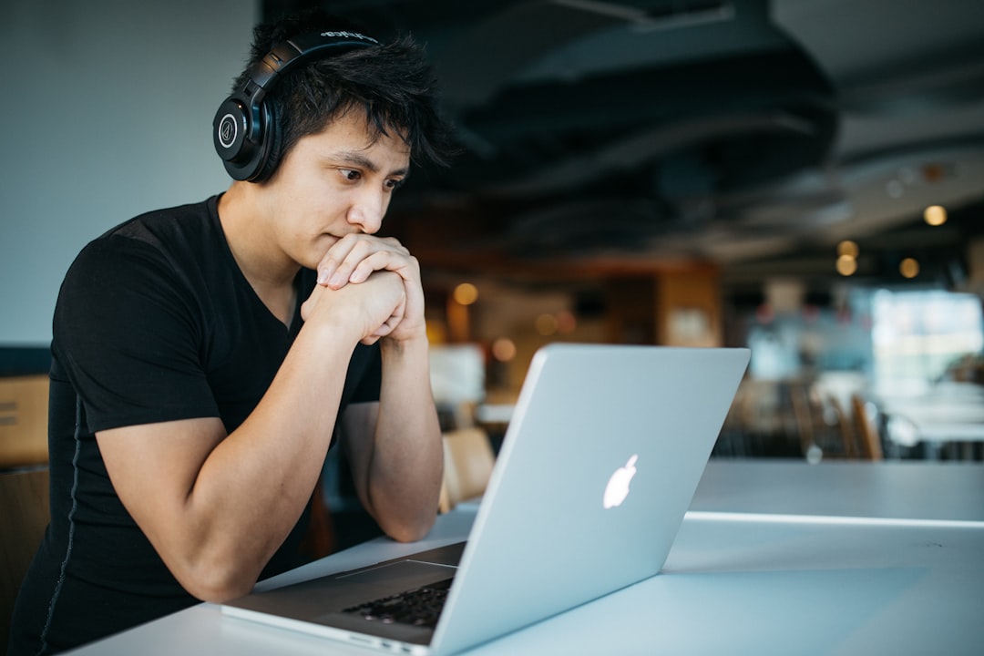 Person wearing headphones working focused at an office desk