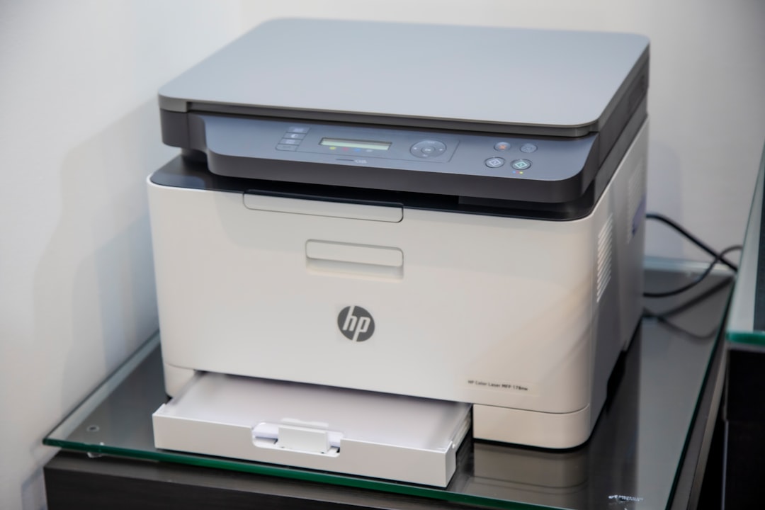 Laser printer on a stand in an office corner