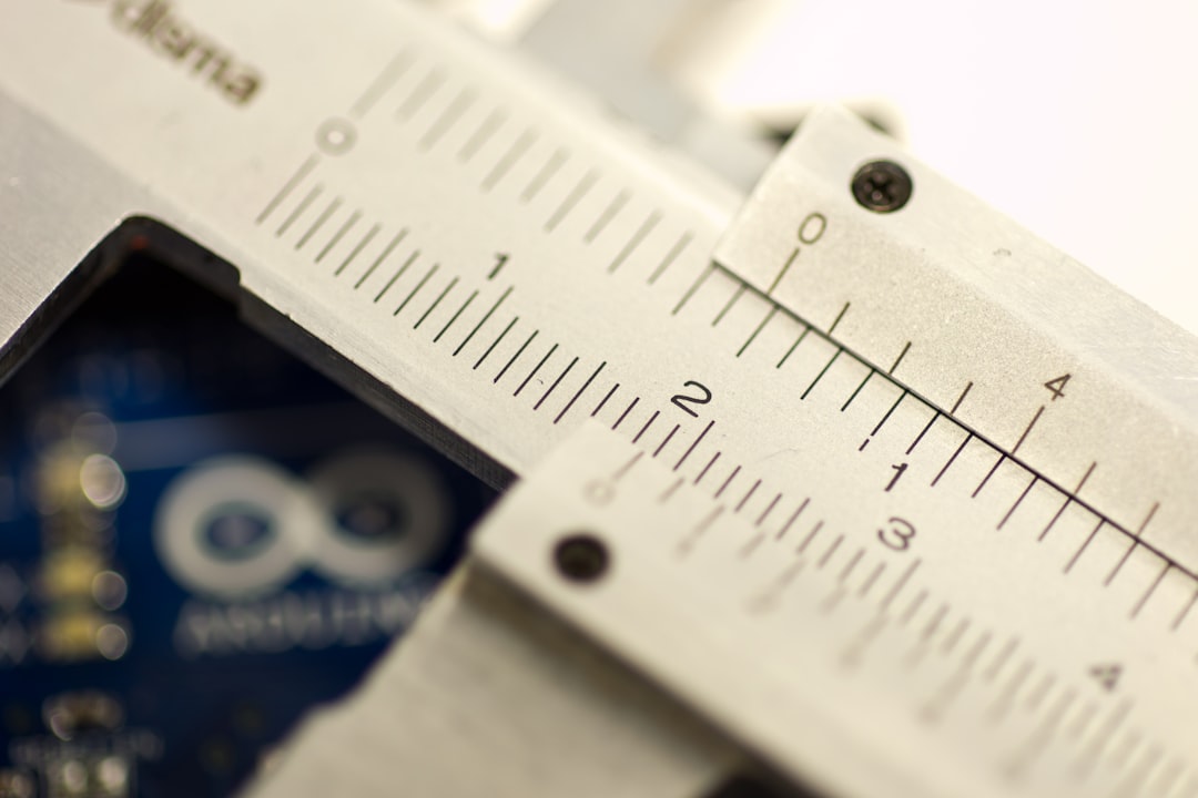 Close-up of digital caliper jaws measuring a small object