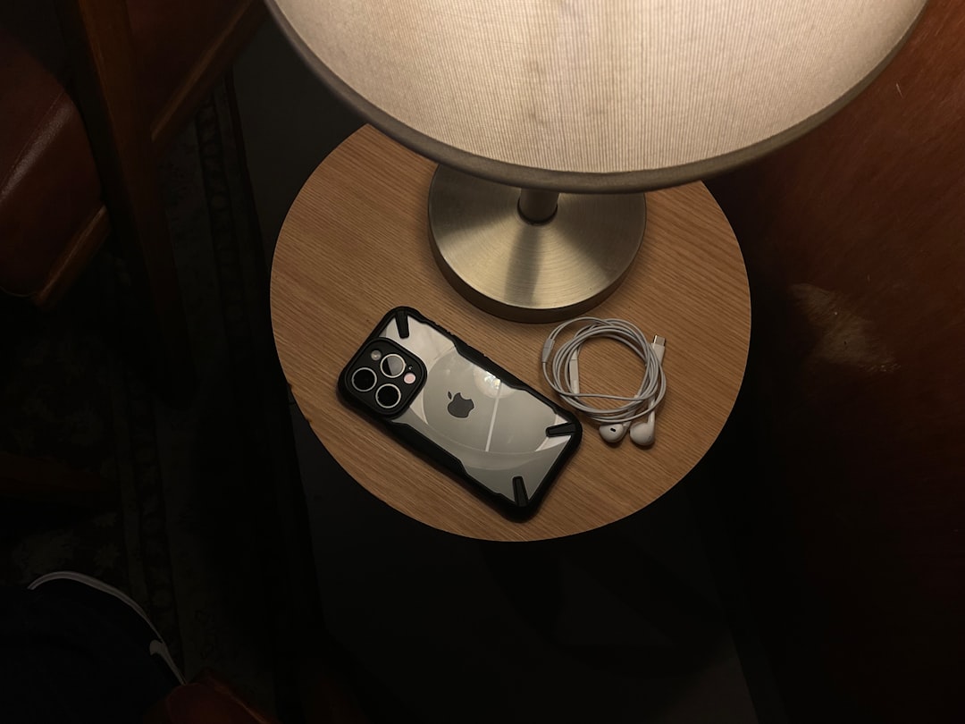 Phone resting on a charging stand on a nightstand