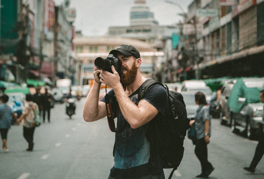 Vlogger filming handheld while walking through a city street