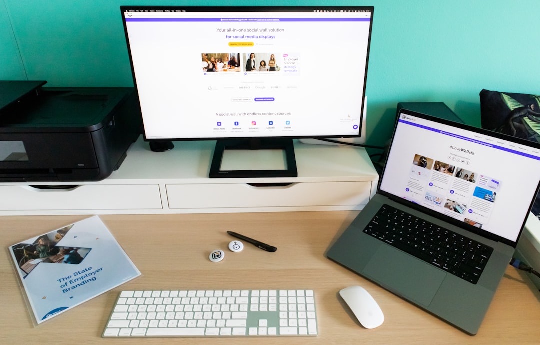 Desk setup with laptop, monitor and printer