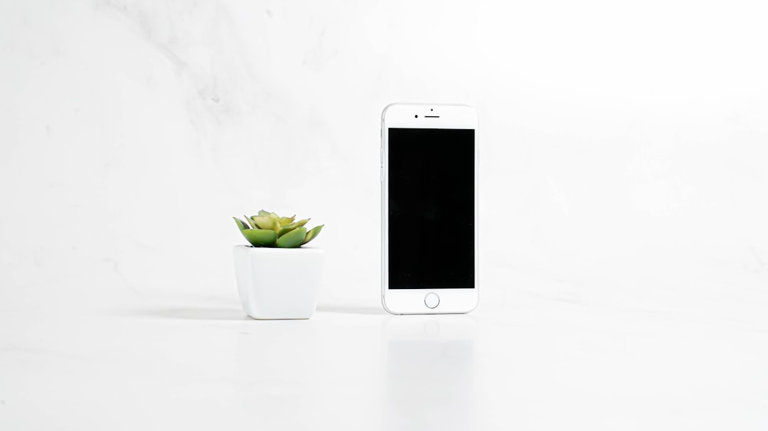 Modern smartphone displayed on minimal surface