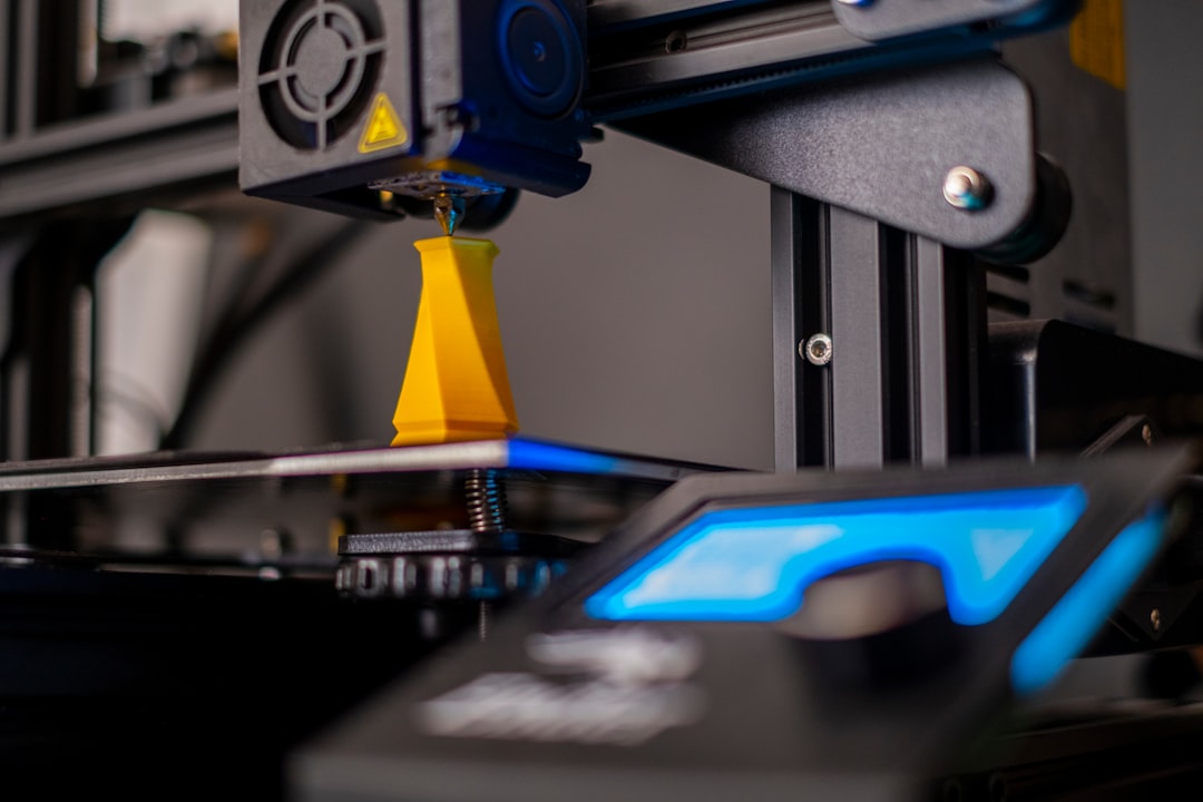 Close-up of a 3D printer nozzle extruding melted filament onto a print in progress