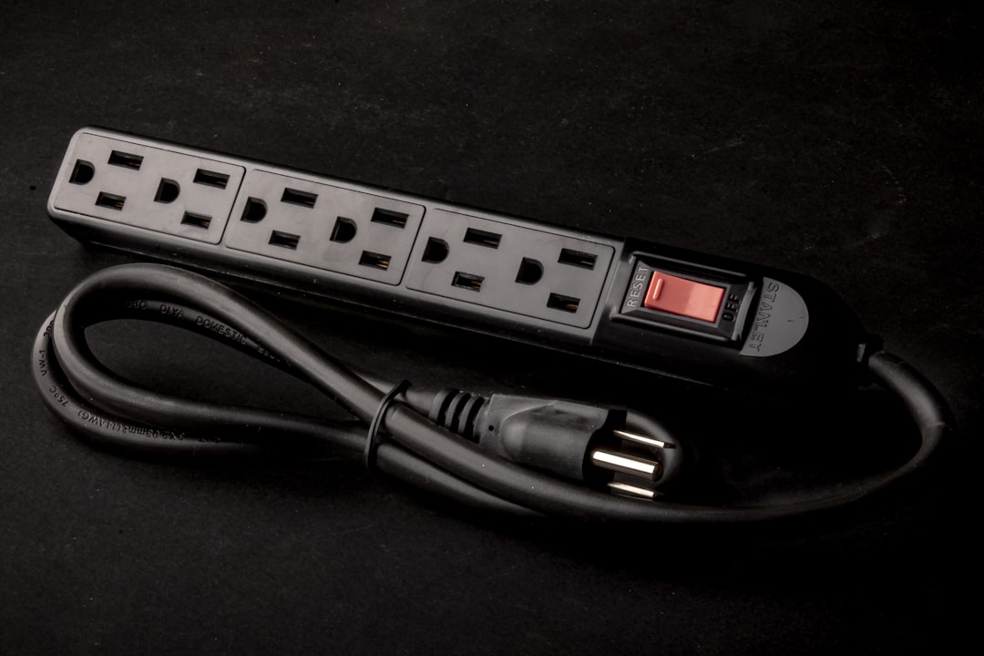 Surge protector power strip mounted under desk