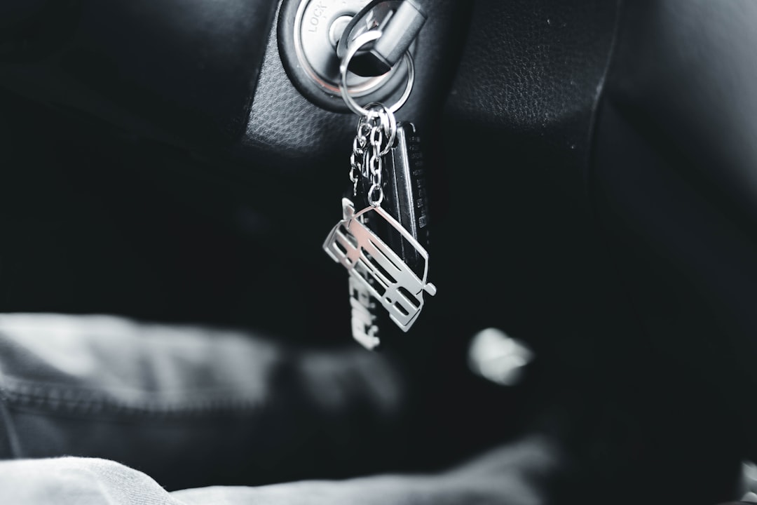 Car keys on a keyring hanging from a car ignition