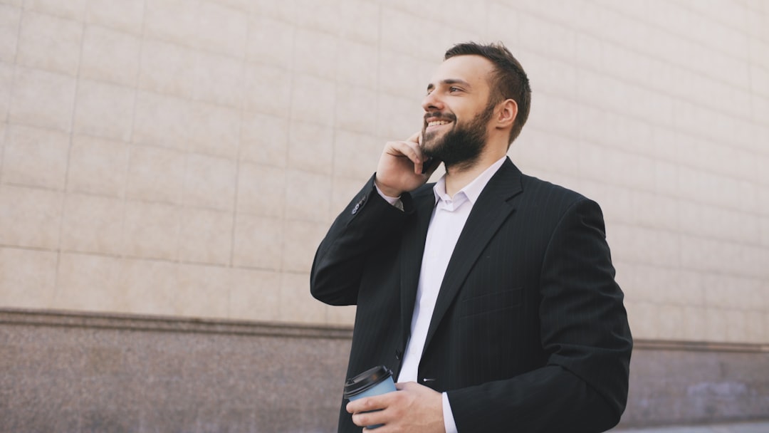 Man taking a phone call while walking a city street