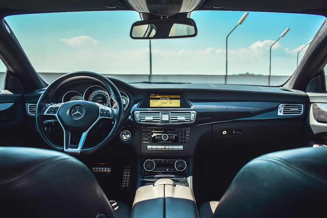 Car interior with dashboard and steering wheel visible from the driver's perspective