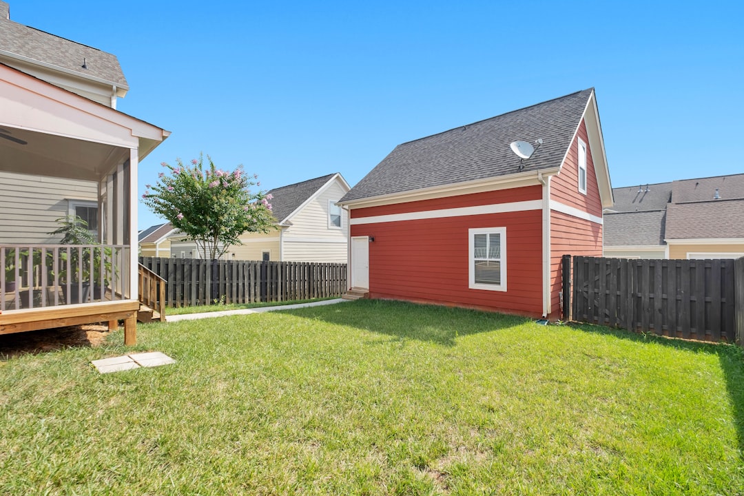 Green suburban backyard lawn stretching out from a house