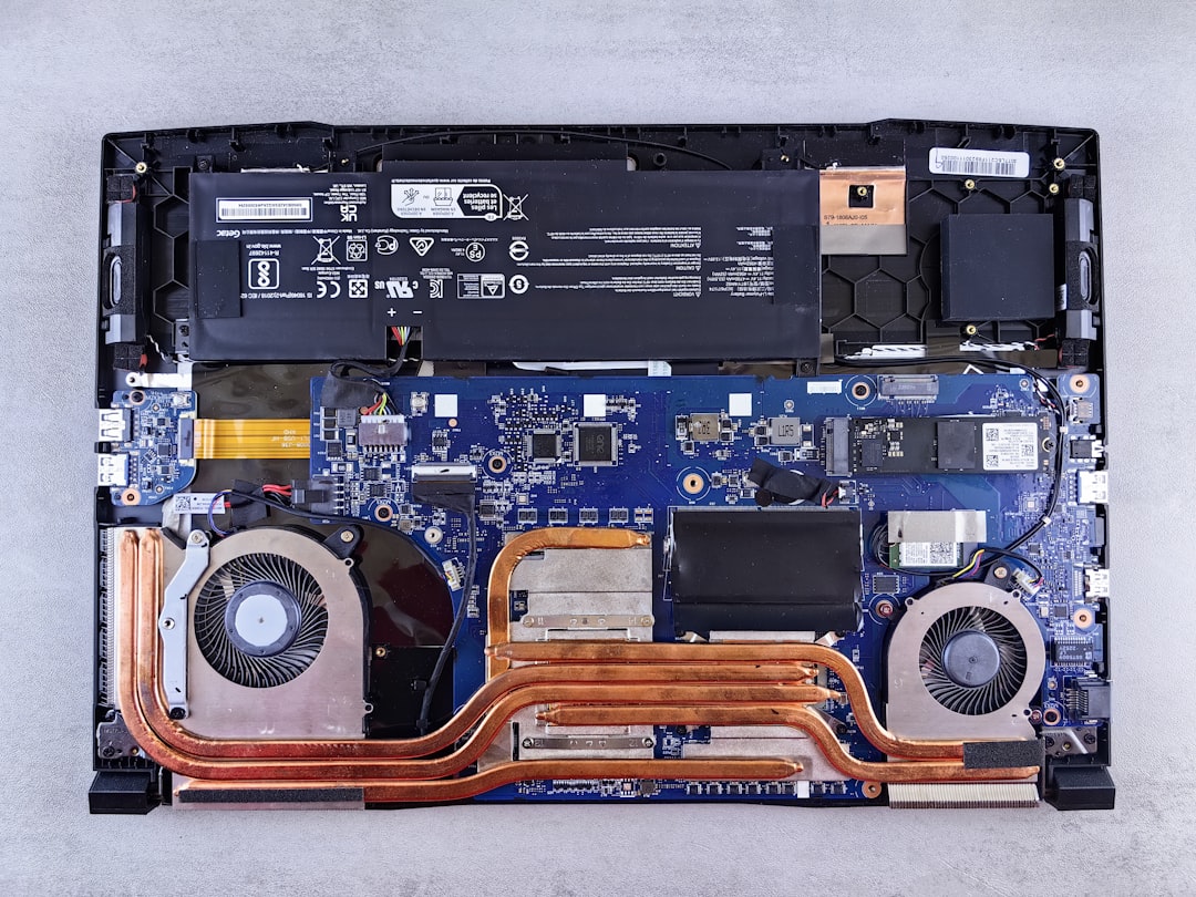 Laptop disassembled into parts on a repair bench