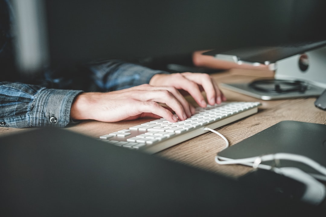 Person typing on mechanical keyboard at desk